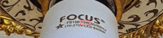 A label on an installed LED bulb: FOCUS(R) <star symbol with the number 5 inside> FS15B 15W 50/60Hz 170-270V-LED 6400K.